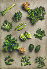 Wall Mural - Healthy vegan salad ingredients layout. Flat-lay of different green vegetables and herbs over grey concrete background, top view. Vegetarian, clean eating, raw, Spring light food concept