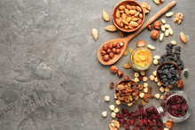 Assortment Of Tasty Dried Fruits And Nuts On Grey Background
