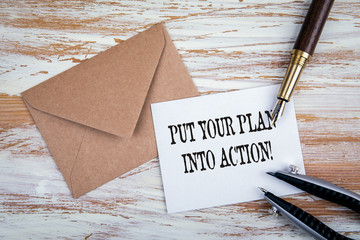 Wall Mural - PUT YOUR PLAN INTO ACTION. Paper letter and pen on a wooden table