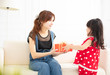 © Tom Wang - little girl  giving a gift box to her mother