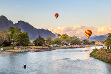 Colorful Hot Air Balloon Floating Above The River In Vang Vieng City , Laos At Sunset 
