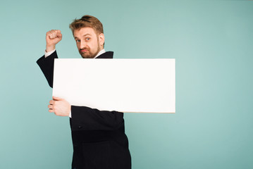 Funny young business man showing blank signboard