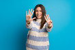 © luismolinero - Young woman over blue wall counting eight with fingers