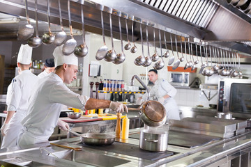 Wall Mural - work of a group of chefs in a luxury restaurant.