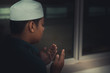 A Young asian muslim man praying on sunset,Ramadan festival concept