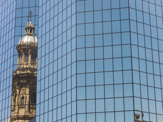 Wall Mural - Reflection in a glass building of the Metropolitan Cathedral of Santiago, in the Armsas square. Chile