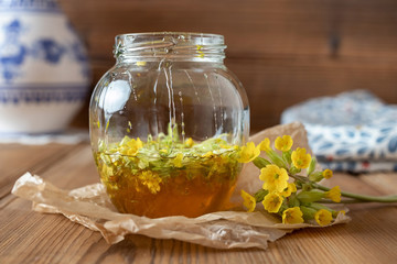 Wall Mural - Preparation of a syrup from primrose flowers and honey