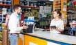 © JackF - woman seller consulting   male customer at the counter  in tool-ware shop