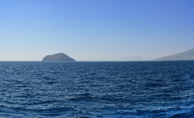 Wall Mural - Panorama of the Aegean Sea overlooking the next islands and mountains in the summer evening after a decline. it is sewed from four vertical pictures