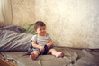 © natalialeb - funny chubby baby with phone plays and nibbles