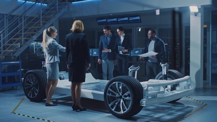 Poster - Diverse Team of Automobile Design Engineers Introducing Futuristic Autonomous Electric Car Platform Chassis to a Group of Investors and Businesspeople. Vehicle Frame with Wheels, Engine and Battery