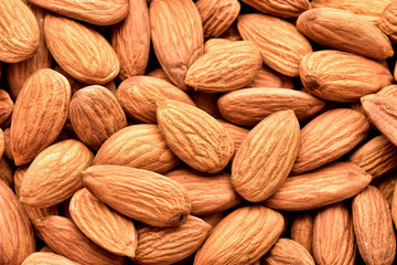 Wall Mural - Almonds close-up as background, macro