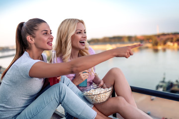 Wall Mural - Two girls having fun on rooftop