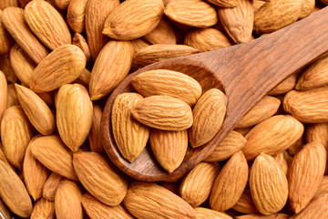 Poster - Almonds in wooden spoon, top view