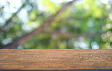 Empty dark wooden table in front of abstract blurred bokeh background of restaurant . can be used for display or montage your products.Mock up for space.