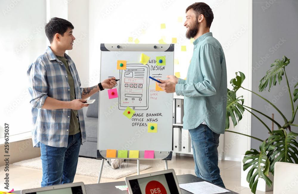 Young IT designers working in office