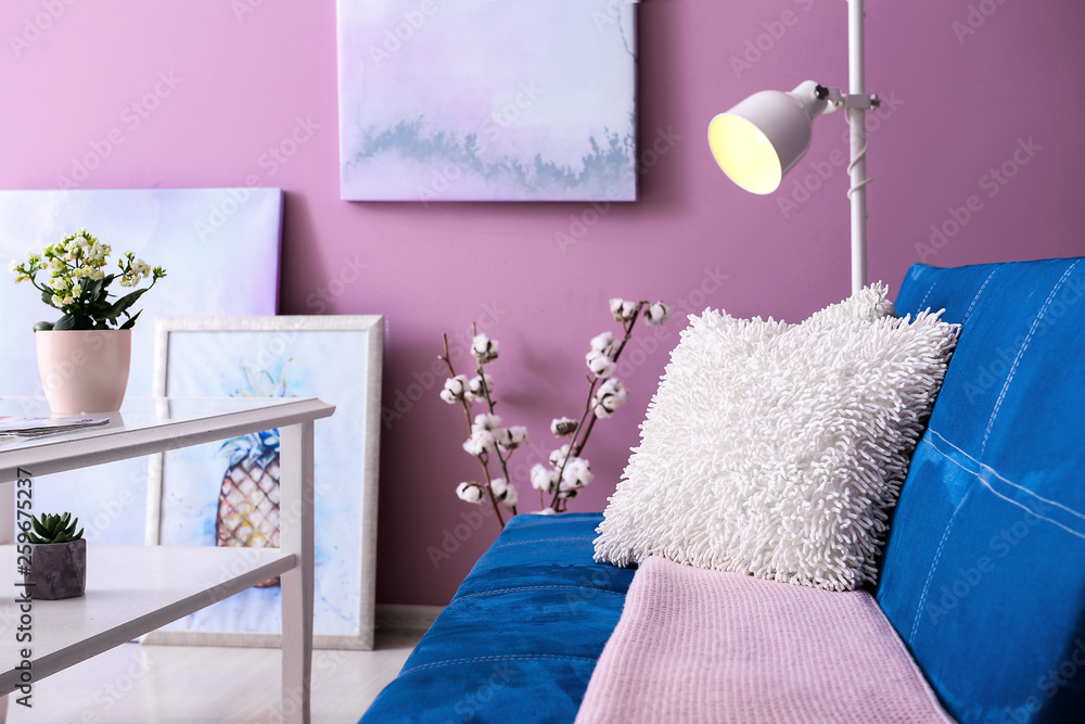 Interior of modern room with comfortable sofa and table