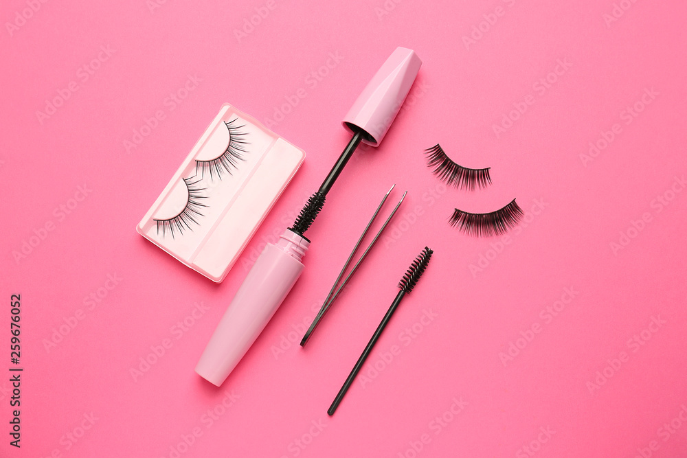 Mascara with false eyelashes and pincers on color background