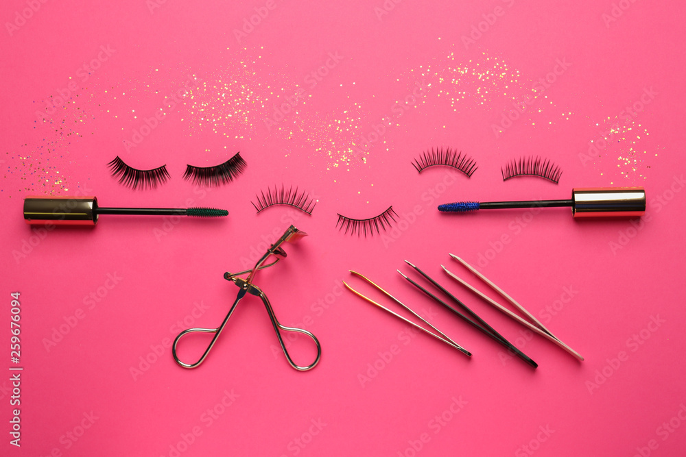 Mascara with false eyelashes and tools on color background