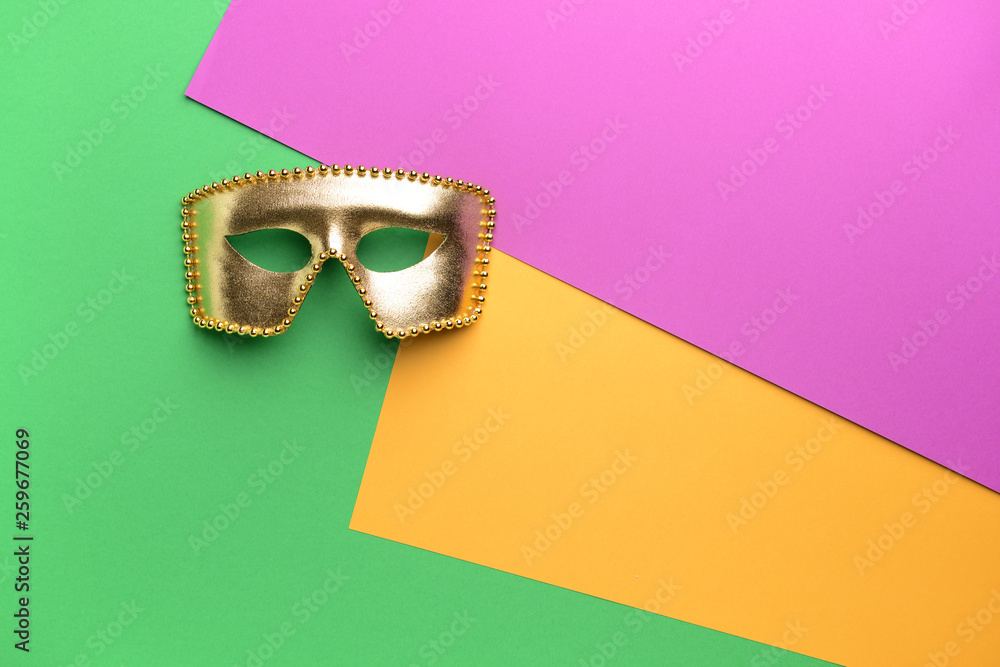 Festive mask on color background