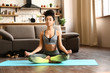 © Pixel-Shot - Sporty African-American woman practicing yoga at home