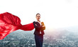 © adam121 - Concept of power and sucess with businesswoman superhero in big city