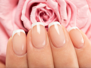 Wall Mural - Woman gets manicure procedure in a spa salon. Beautiful female hands.