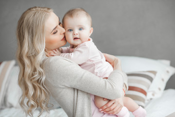 young mother with her little cute baby daughter. little baby girl and her mom. mama with her child i