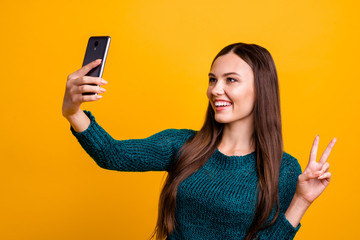 Sticker - Close up photo beautiful her she lady hold arm hand telephone make take selfies show fingers v-sign symbol say hi blog followers wear green knitted pullover jumper isolated yellow background