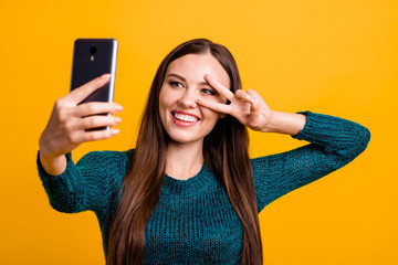 Poster - Close up photo beautiful funky her she lady hold arm hand telephone make take selfies show fingers v-sign symbol say hi blog followers wear green knitted pullover jumper isolated yellow background