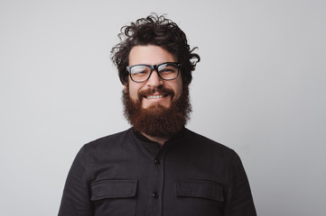 Wall Mural - Portrait of happy and handsome bearded man looking at the camera