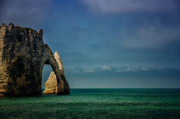 Wall Mural - Etretat is best known for its white chalk cliffs, including natural arches. Normandy, France, Europe