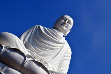  buddha statue against a clear blue sky