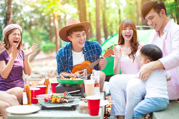 Wall Mural - happy young friends group enjoying picnic party and camping