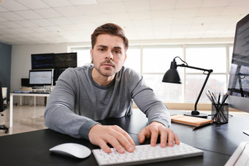 Male programmer working in office