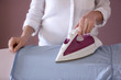 © Pixel-Shot - Woman ironing clothes at home