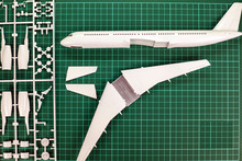 Aircraft Layout Assembly,  Model   Plane Building On Wooden Table With Scale Modelling Tools.