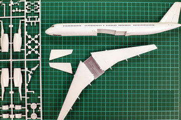 aircraft layout assembly,  model   plane building on wooden table with scale modelling tools.