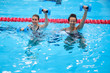 © Nejron Photo - Multiracial couple attending water aerobics class in a swimming pool