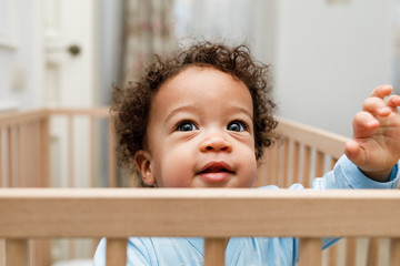 Close up portrait of little baby boy in crib