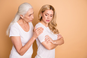 Wall Mural - Portrait of nice-looking attractive gloomy grumpy moody ladies wearing white outfit granny mom supporting grandchild cheering up isolated over beige pastel background