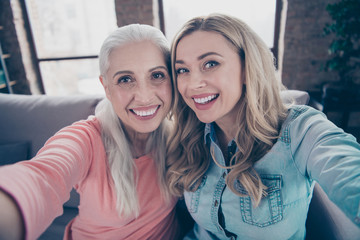 Sticker - Close up photo two beautiful she her ladies funky granny granddaughter relatives mom mommy make take selfies telephone hands arms good mood sit couch divan sofa house indoors