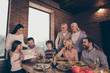 © deagreez - Close up photo people big family company brother sister granny mom grandpa son daughter give large giftbox box package daddy dad father sit festive holiday tasty dishes table loft house indoors