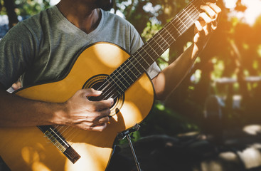 Man playing classic guitar at park