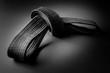 Black judo, aikido, or karate belt, tied in a knot, isolated on black background