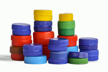 colored plastic caps, stacked on top of each other, isolated on white background