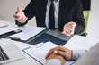 © Ngampol - Employer or recruiter holding reading a resume during about colloquy his profile of candidate, employer in suit is conducting a job interview, manager resource employment and recruitment concept
