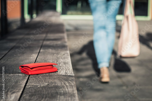 Woman Is Leaving From A Bench Where She Forgot Her Leather Wallet