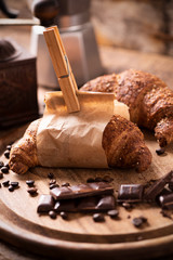 Coffee cup with a croissant and fresh coffee