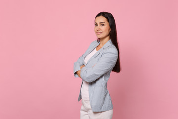 Wall Mural - Portrait of attractive smiling young woman in striped jacket holding hands crossed isolated on pink pastel wall background in studio. People sincere emotions, lifestyle concept. Mock up copy space.